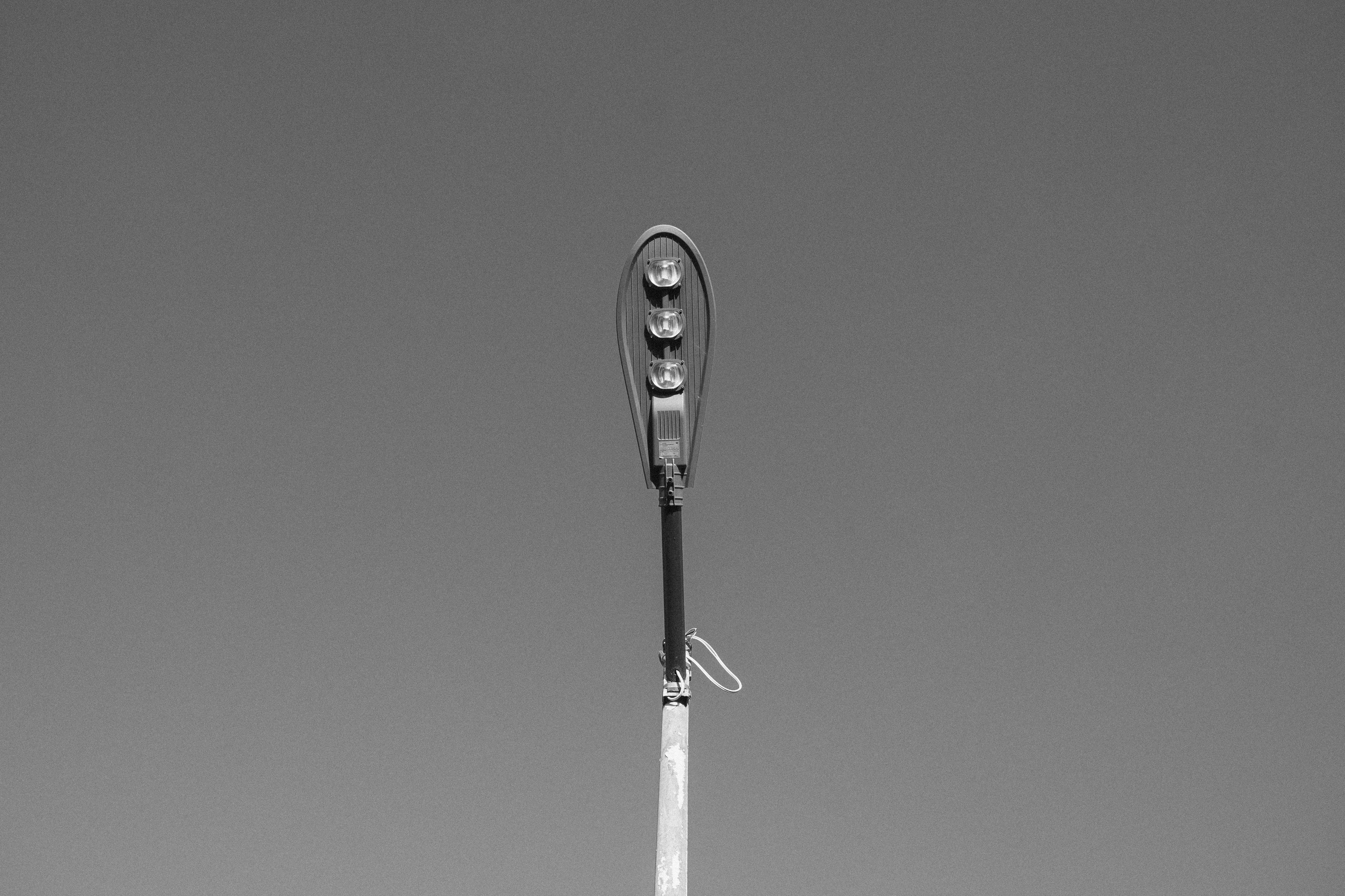 Free Black and white image of a single streetlight against a clear sky, minimalistic style. Stock Photo
