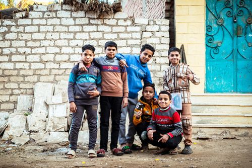 Free A group of boys smiling in a colorful urban street in Egypt. Stock Photo