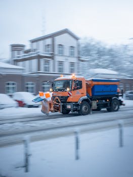 Snowplow truck clearing snow on a winter day in Hamburg, showcasing city maintenance