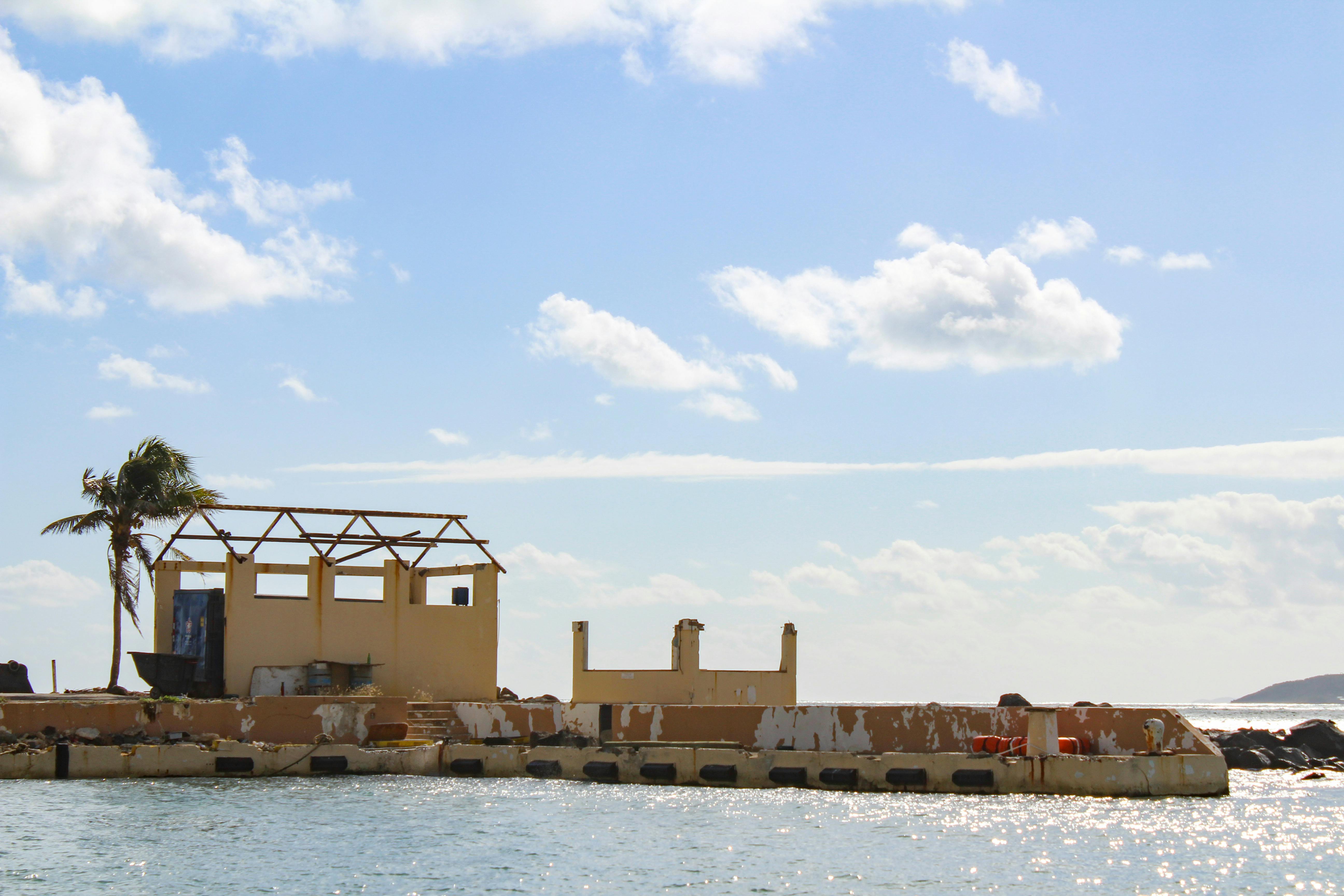 Hurricane damage visible on a coastal structure
