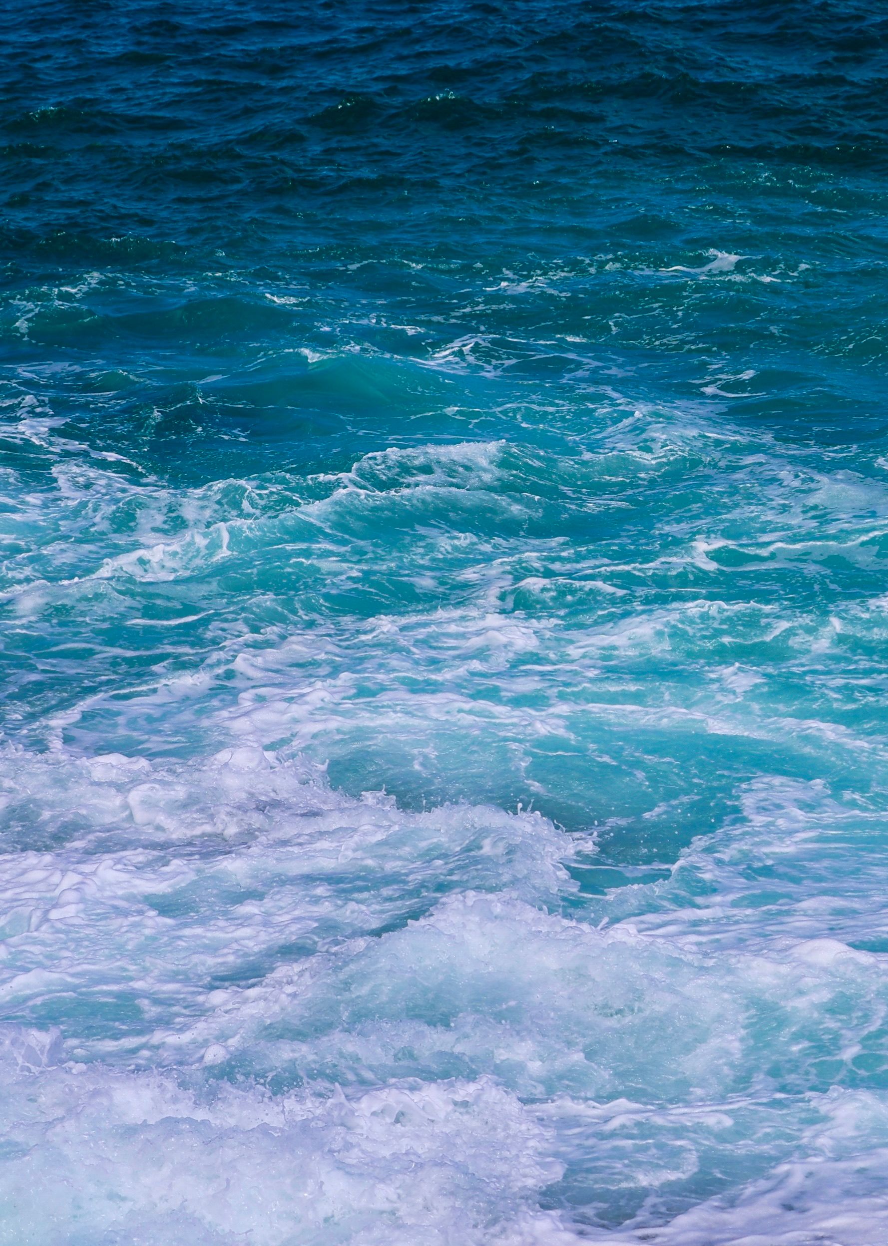 Dynamic ocean waves in vibrant blues and whites creating a perfect surf scene.