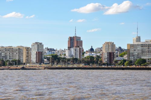 Free Skyline of Montevideo, Uruguay, overlooking the coastal waterfront under a bright blue sky. Stock Photo