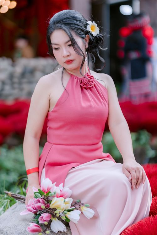 Elegant Woman in Pink Holding Flowers Outdoors · Free Stock Photo