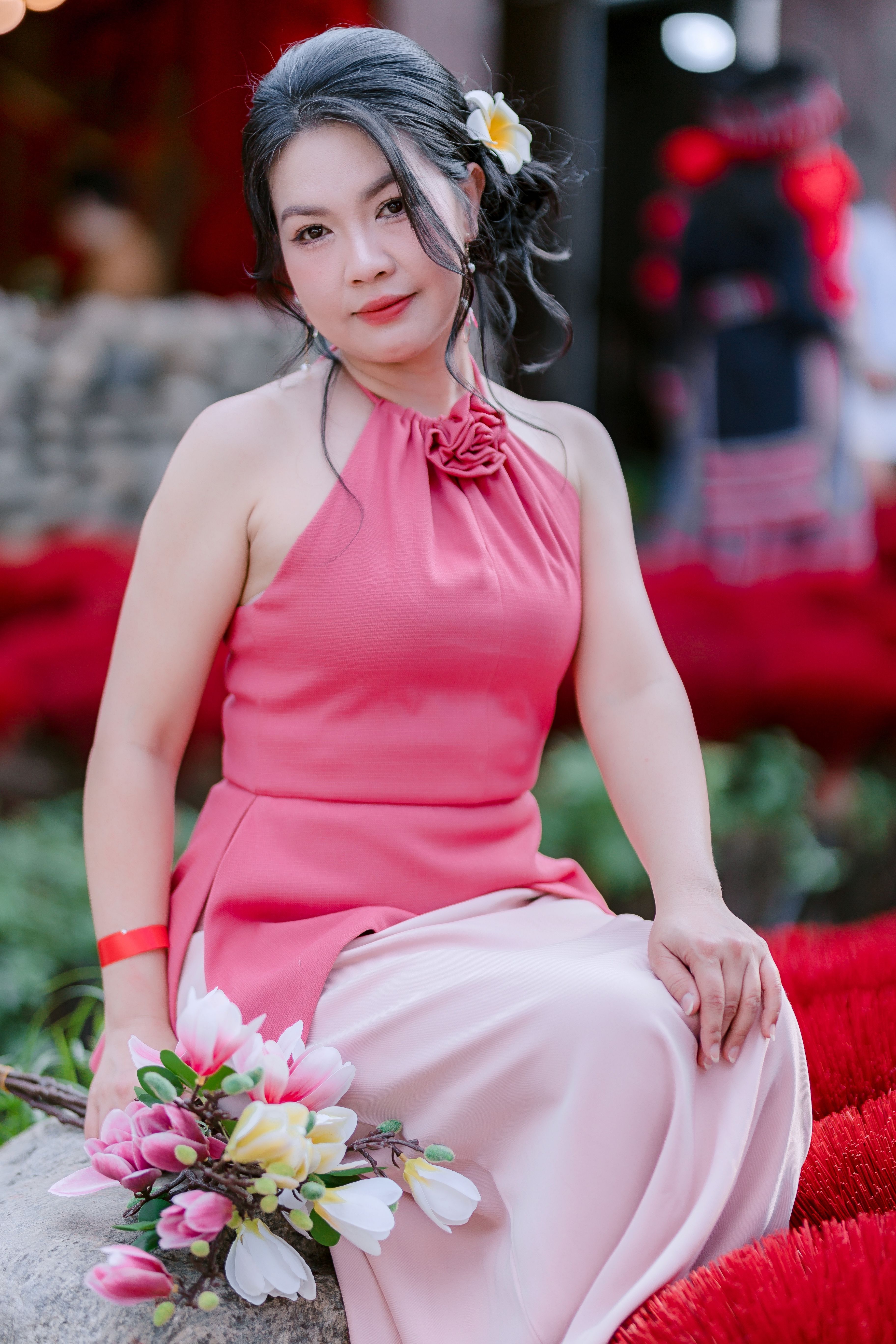Elegant Woman in Pink Dress Holding Flowers · Free Stock Photo