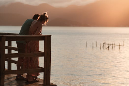 Couple enjoying a serene sunset on a lakeside deck in Santa Catarina, Brazil.