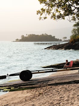 Peaceful beach at sunset in Santa Catarina, Brazil with a lone person enjoying the calm view.
