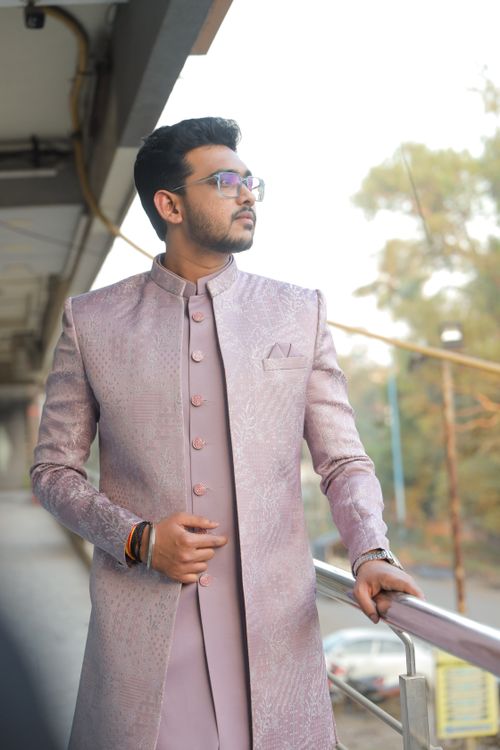 Free A man in traditional Indian attire poses confidently on an outdoor balcony. Stock Photo