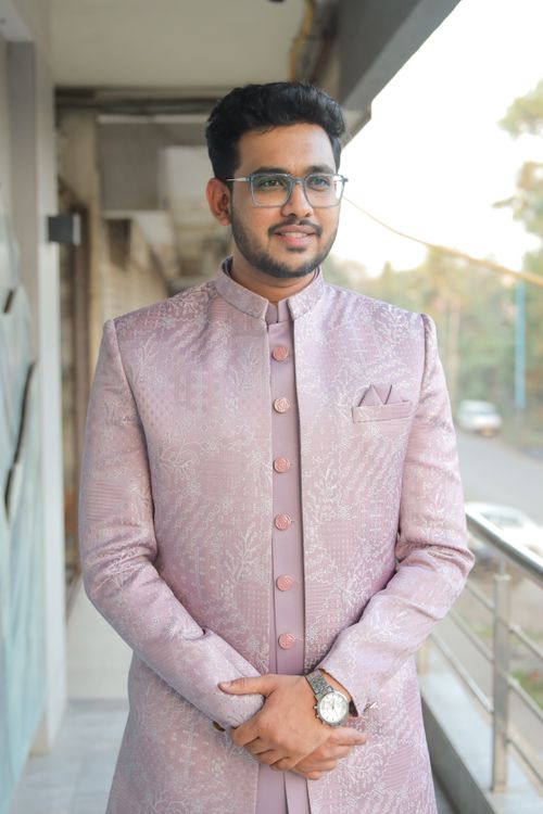 Free Portrait of a young South Asian man wearing traditional attire and glasses outdoors. Stock Photo