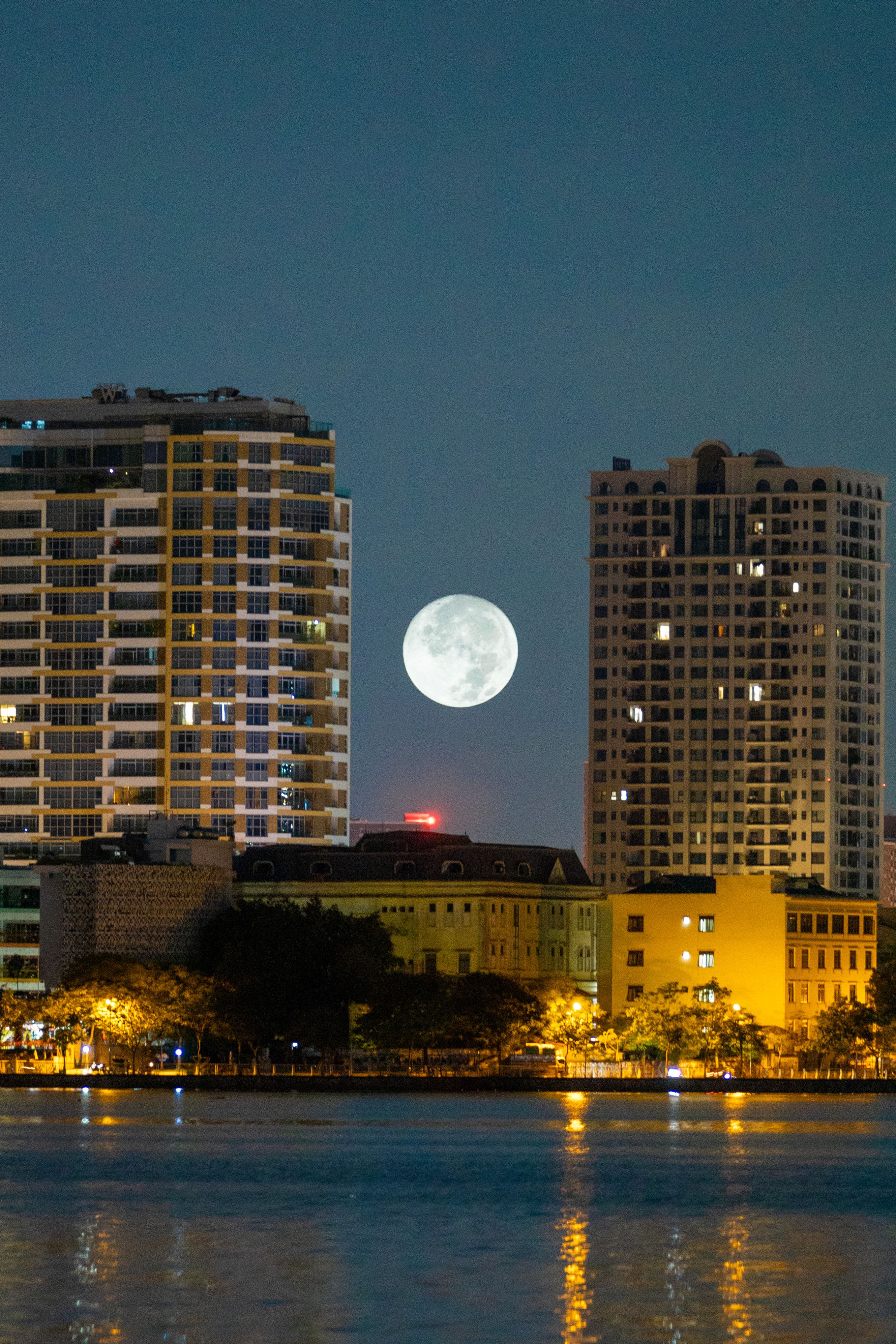 Full Moon Between Skyscrapers at Night · Free Stock Photo