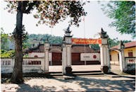 Traditional Vietnamese Temple Entrance under Trees