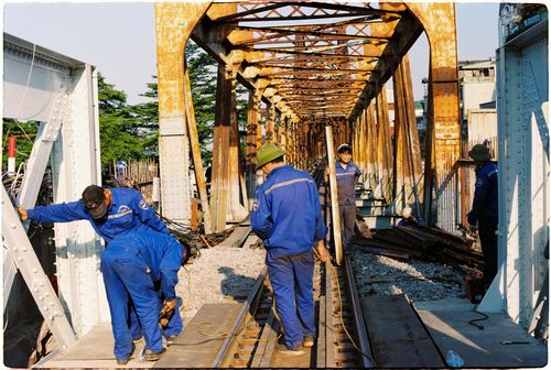 Free Team of workers repairing a railway bridge during the day. Stock Photo
