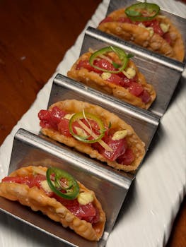 Fresh tuna tartar tacos topped with jalapeño slices, perfect for gourmet dining.