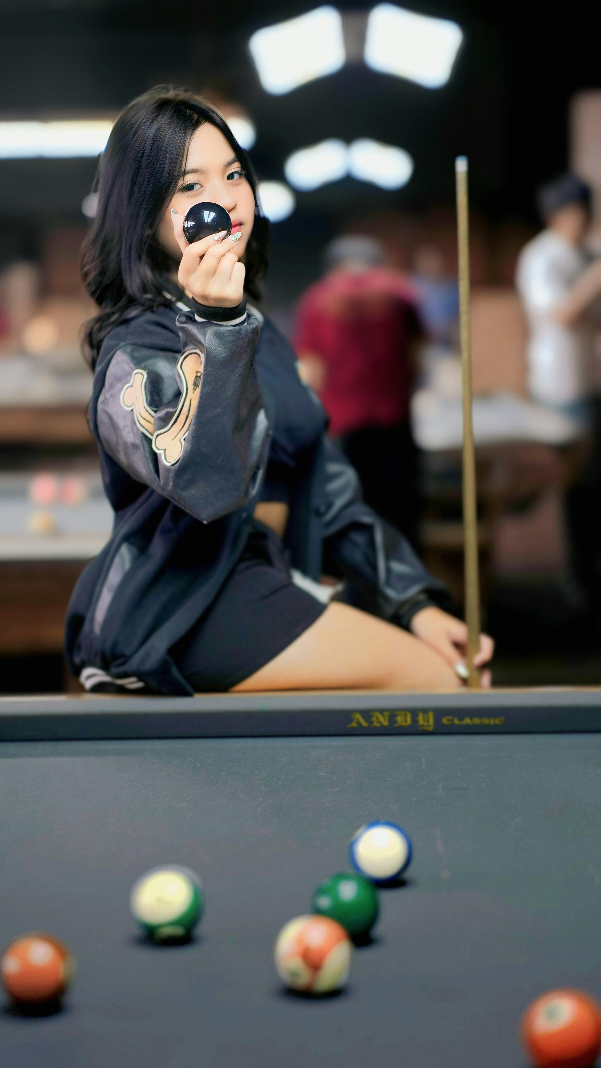young woman posing in billiards hall