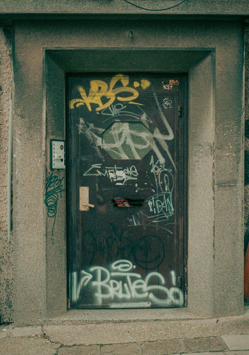Free A street entrance door covered with graffiti in Varna, Bulgaria, showcasing urban art culture. Stock Photo