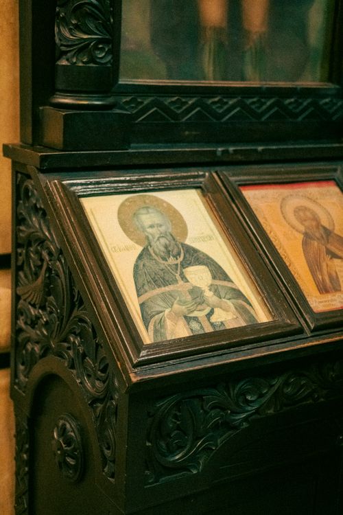 Free Orthodox religious icons displayed on an intricately carved wooden stand in Varna, Bulgaria. Stock Photo