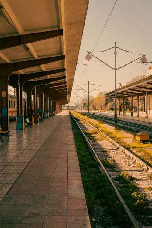Free Empty train platform in Varna, Bulgaria, bathed in warm golden hour light. Stock Photo
