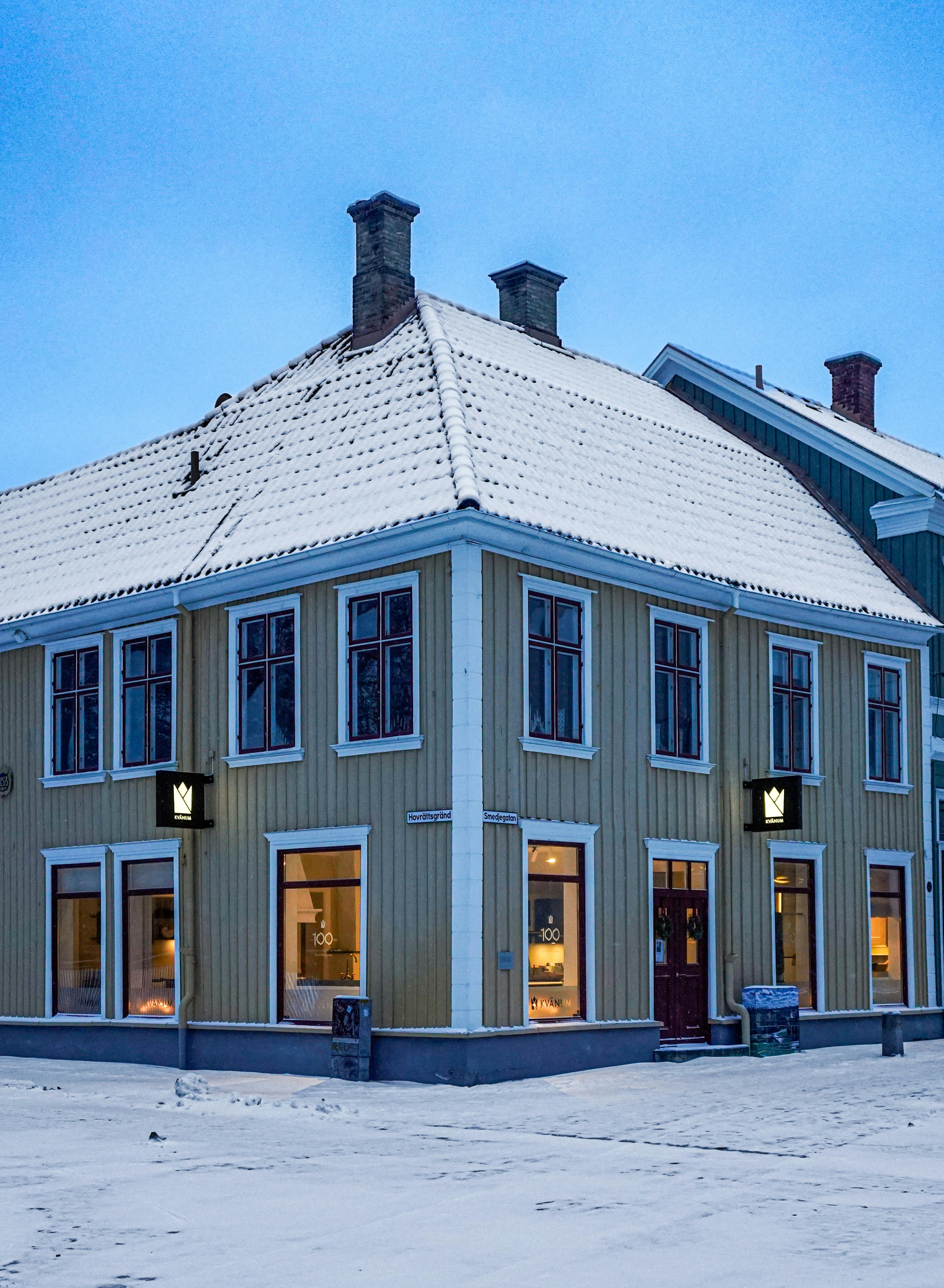 Charming snow-covered building in Jönköping, Sweden, showcasing classic Scandinavian architecture at dusk.