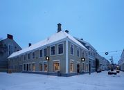 Charming snow-covered street and buildings in Jönköping, Sweden, during winter's twilight.