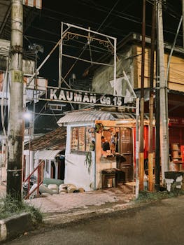 Quaint street shop in Kauman, Indonesia, captured at night, showcasing local architecture.