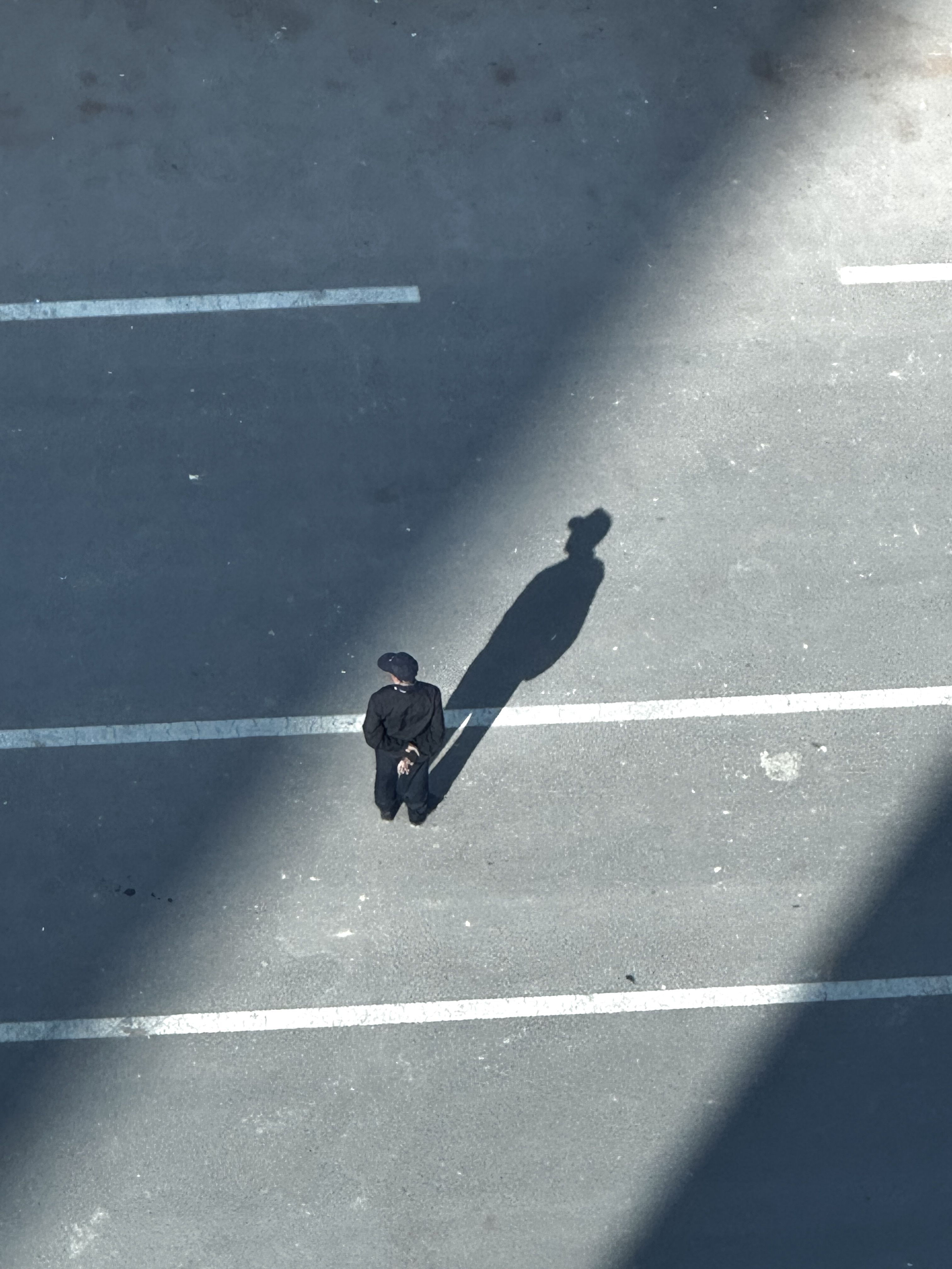 Solitary Figure with Shadow in Urban Setting · Free Stock Photo
