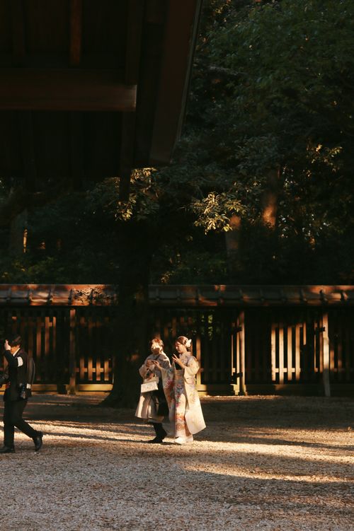 Free People in traditional attire at sunset in Meiji Shrine, Tokyo, Japan. Stock Photo