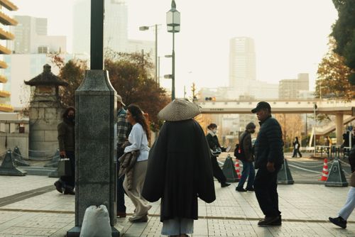 Free Candid street photo capturing urban life with people walking in varied outfits. Stock Photo
