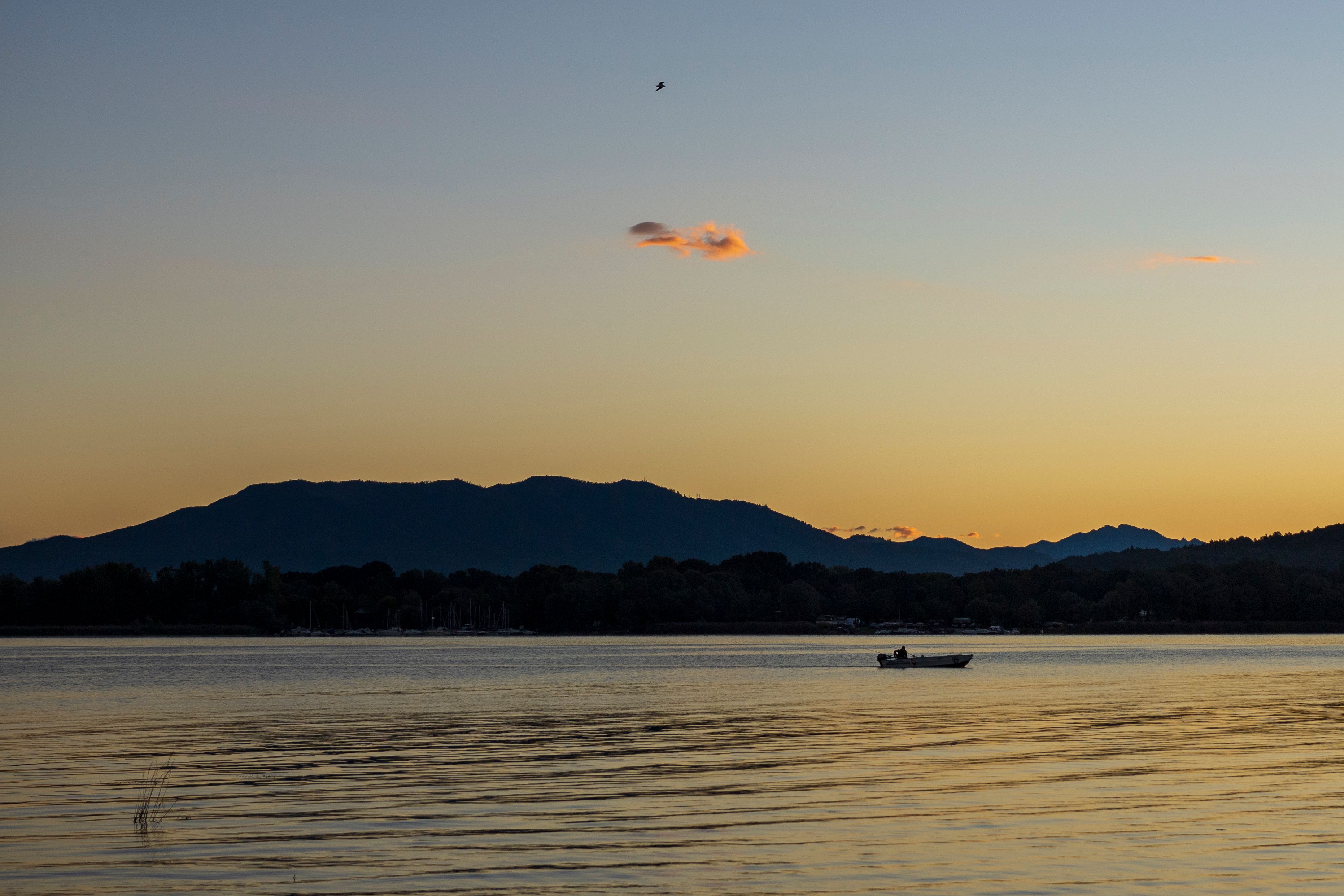 Tranquil Lake Sunset with Silhouetted Mountains · Free Stock Photo