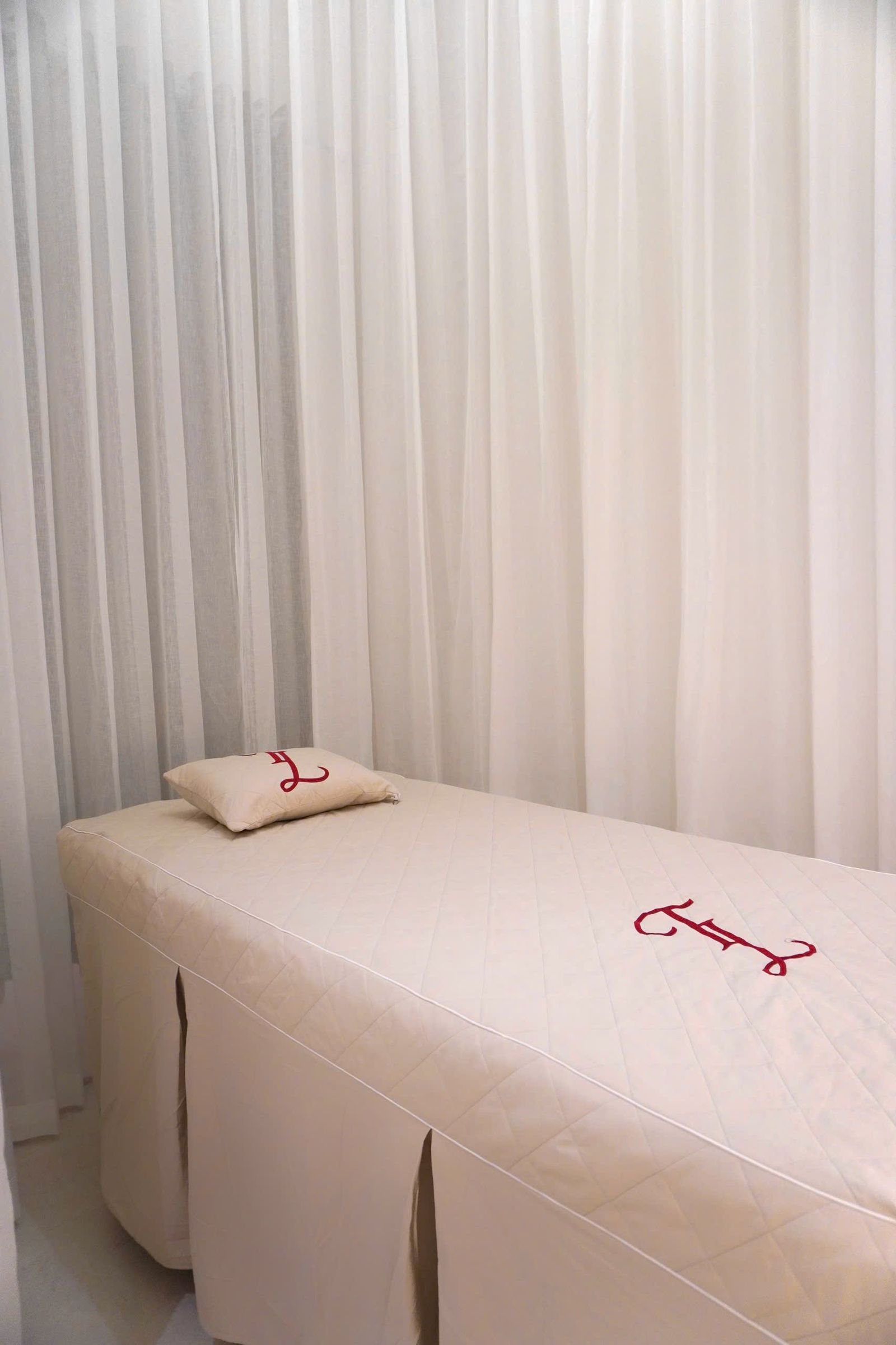 A massage table prepared with fresh linen and oils