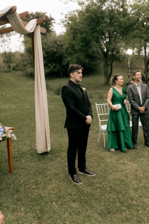 Free A serene outdoor wedding scene featuring a best man in a black suit standing near the altar. Stock Photo