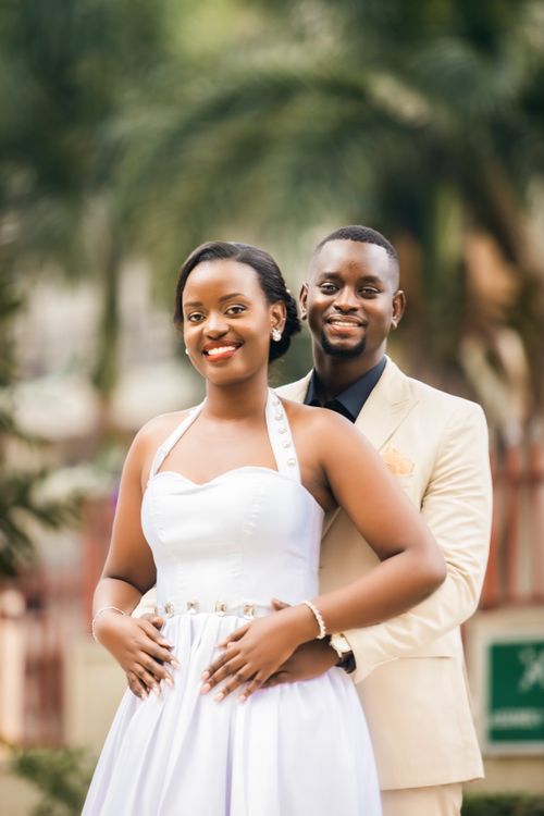 Free Charming couple in elegant attire posing outdoors, radiating joy and love. Stock Photo