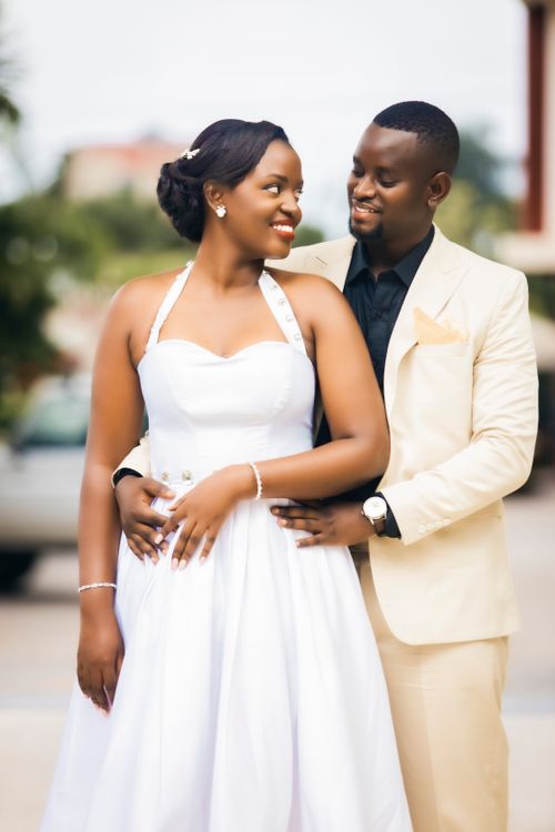 Free Bride and groom posing lovingly outdoors in elegant attire. Stock Photo