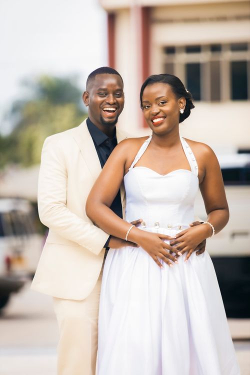 Free Joyful bride and groom posing together in natural light outdoors. Stock Photo