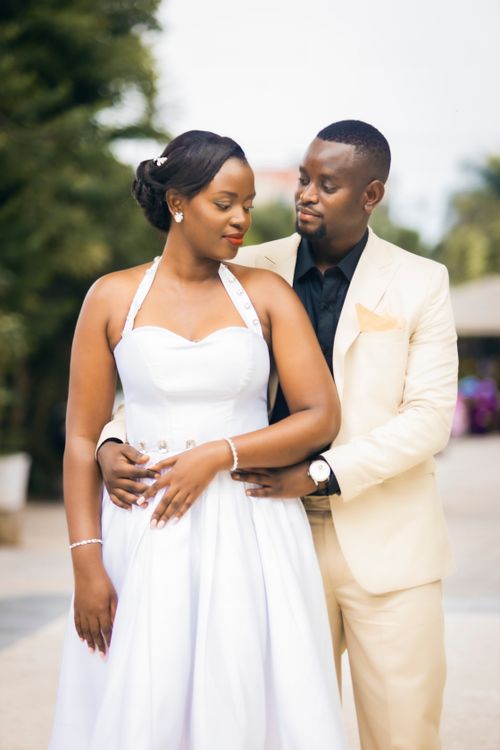 Free A beautiful couple embracing in elegant attire on their wedding day, outdoors. Stock Photo