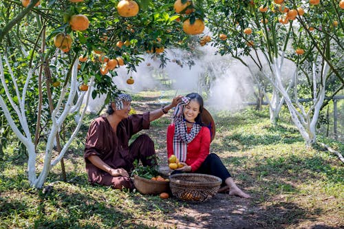 Ethnic couple under fruit trees in garden