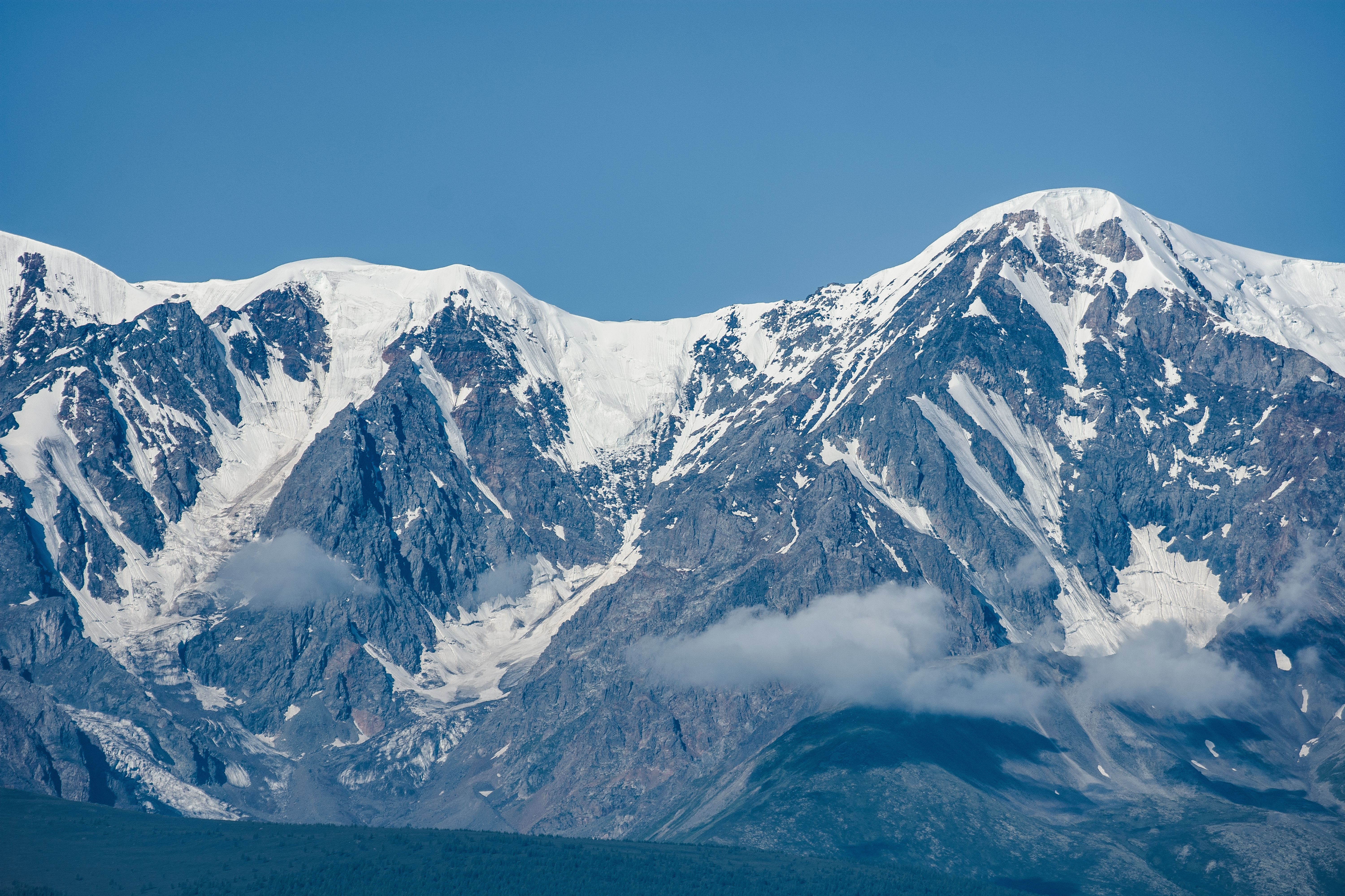 Snowy mountain peak under blue sky