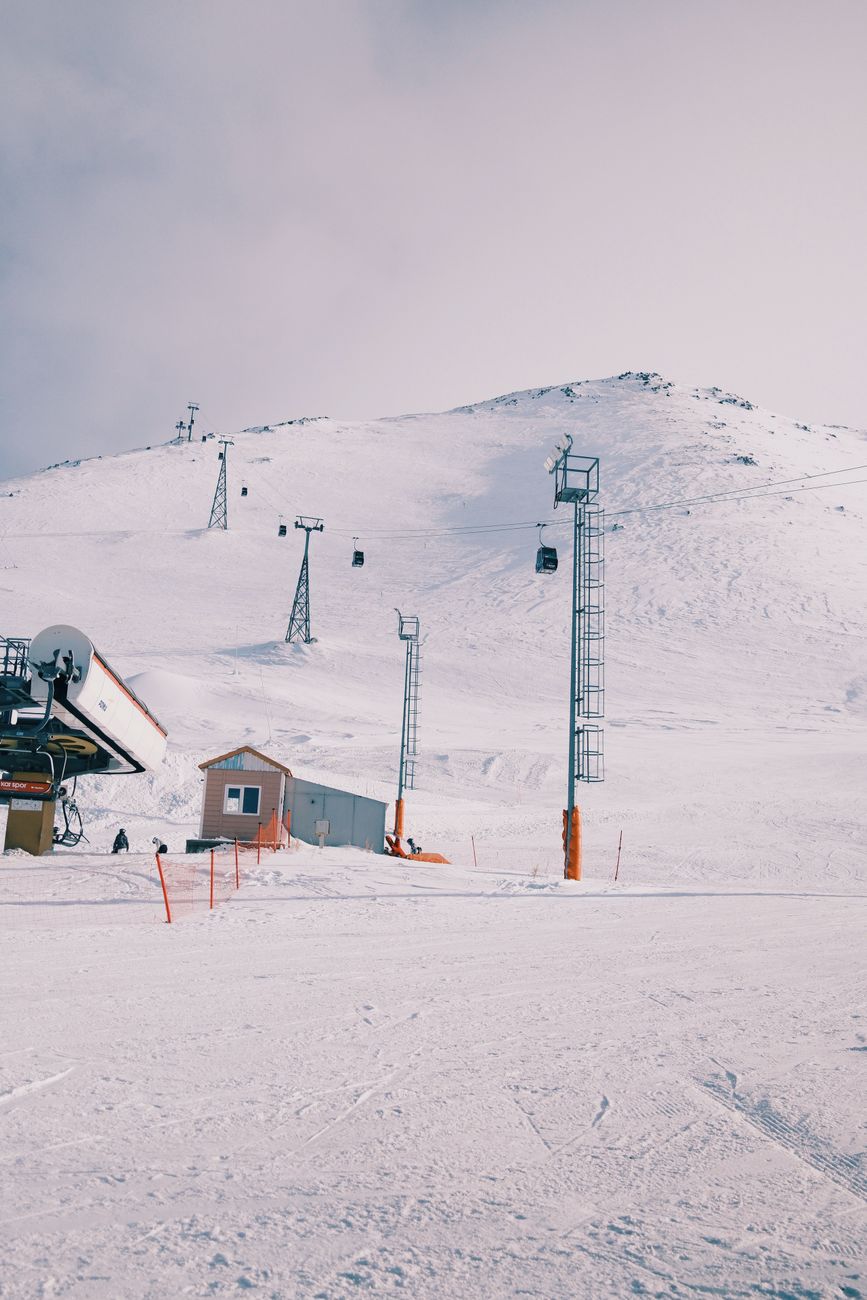 A quiet snow-covered resort with lifts running under a grey sky, the sort of scene that makes Australians ask whether the spend still matches the certainty.