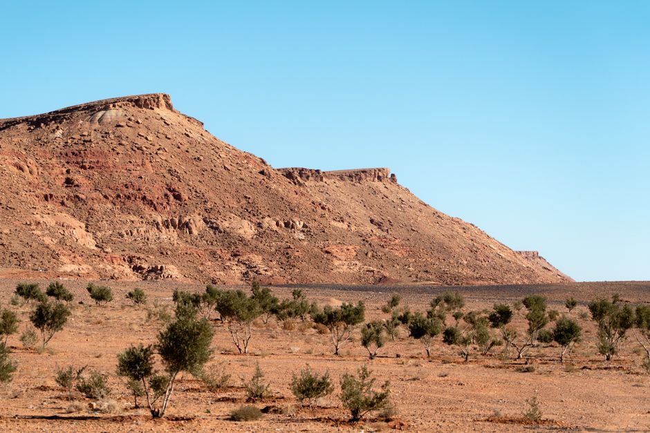 A breathtaking view of a rocky desert landscape in Morocco under a clear blue sky.