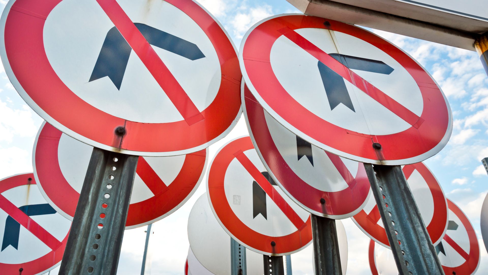 Modafinil Customs Regulations: Understanding the Legal Landscape Multiple no left turn traffic signs displayed together under a blue sky — modafinil customs regulations