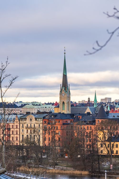 Free Explore the charming skyline of Stockholm with its historic buildings and church spire during a serene winter day. Stock Photo