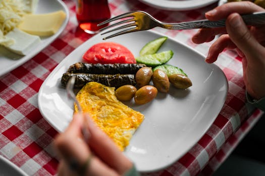 A vibrant plate of traditional Turkish breakfast with olives, omelette, and fresh vegetables in Bursa.