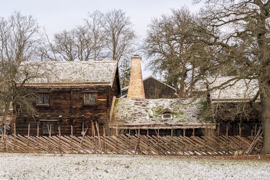Beautiful snowy Swedish farmhouse in winter with rustic charm.