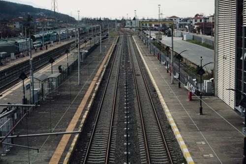 Free Wide-angle view of deserted railway tracks at a serene train station, showcasing urban infrastructure. Stock Photo