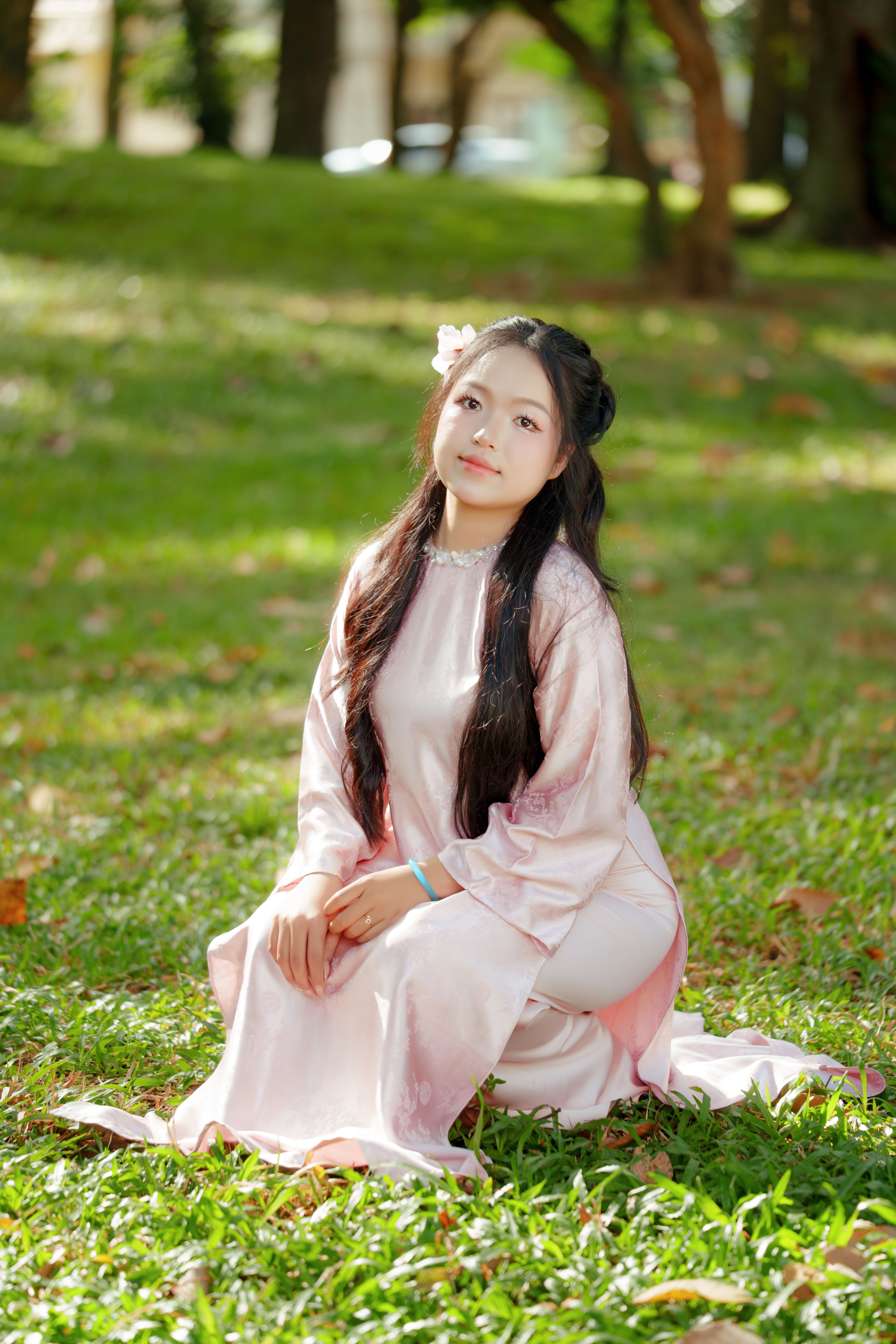 Young Woman in Traditional Dress Sitting Outdoors · Free Stock Photo