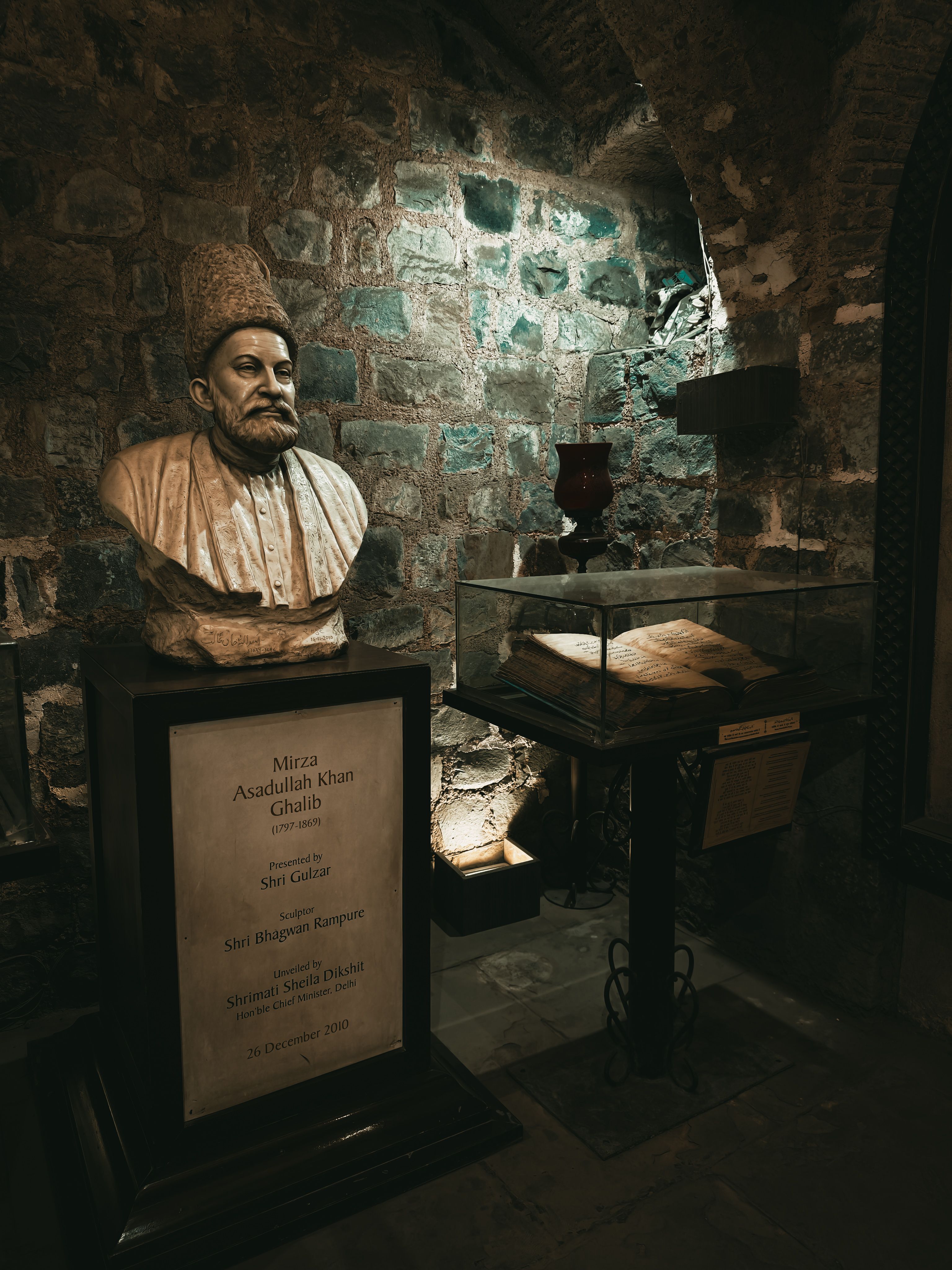 Mirza Ghalib's bust and manuscripts displayed in a Delhi museum exhibit.