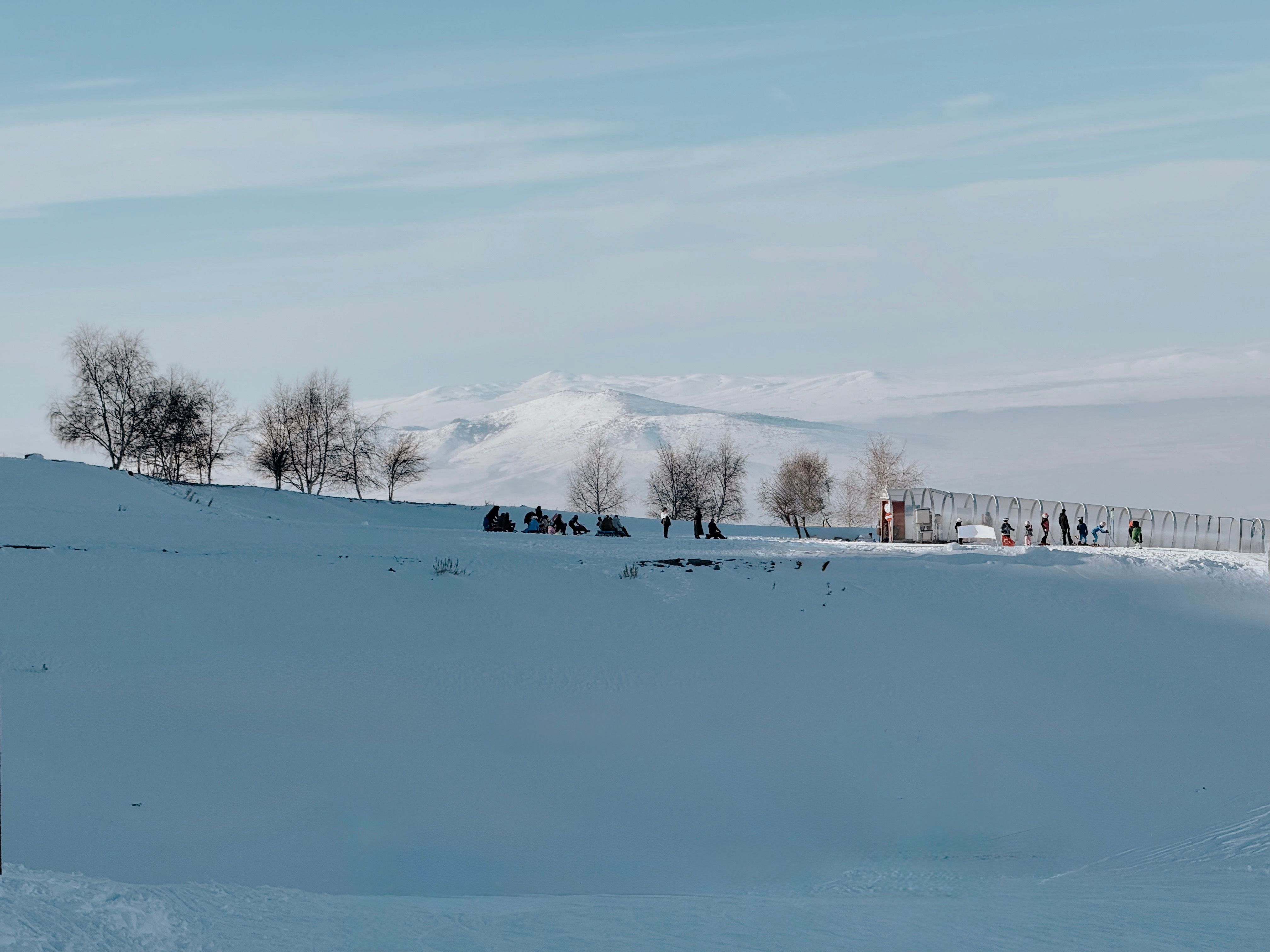 Scenic Winter Landscape with Snow-Covered Mountains · Free Stock Photo