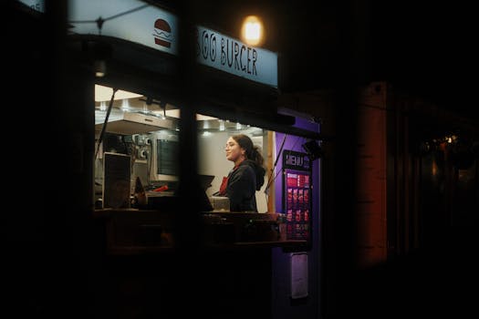A candid shot of a dimly lit burger stall in Dublin, capturing the vibrant nightlife and culinary culture.