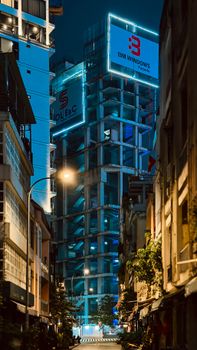 A night scene of modern architecture and street view in Ho Chi Minh City, Vietnam.