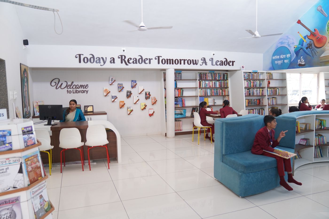 A busy library reading hall with students working at long tables