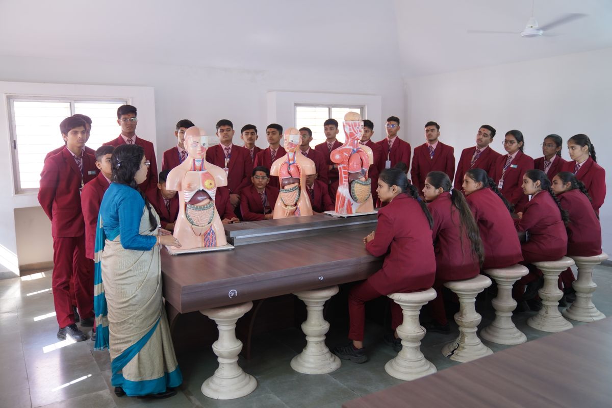 Indian students studying biology with anatomical models in a classroom in Gujarat