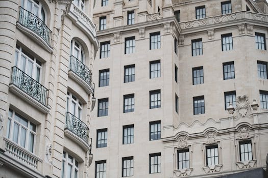 An elegant European-style building facade featuring intricate ironwork and detailed stonework.
